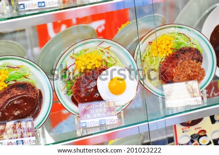 TOKYO, JAPAN - DECEMBER 28, 2011: Plastic food on display in restaurant\'s window on the streets of Tokyo