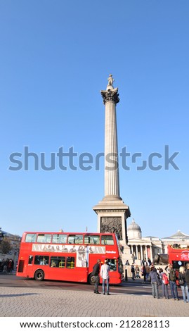 LONDON, UK - NOVEMBER 18, 2011: Tourist bus sightseeing the Nelson\'s Column in Trafalgar Square, London.