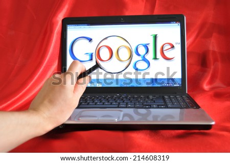 LONDON, UK - SEPTEMBER 3, 2010: Google search concept with hand holding magnifying glass against Google home screen (illustrative editorial)