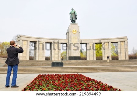 BERLIN, GERMANY - MARCH 30, 2014: Tourist admire the architecture of the Soviet War Memorial (Tiergarten) in Berlin, Germany