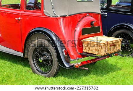 Back view of vintage car with picnic basket