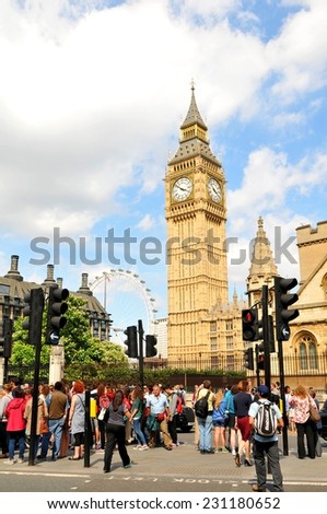 LONDON, UK - JULY 9, 2014: Tourists sightseeing Big Ben in central London on a summer day.