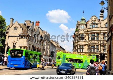 OXFORD, UK - JULY 9, 2014: Tourists walk along high street in central Oxford, England.