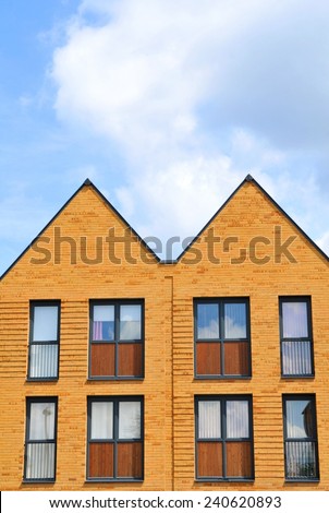 Property development concept with newly built houses against blue sky