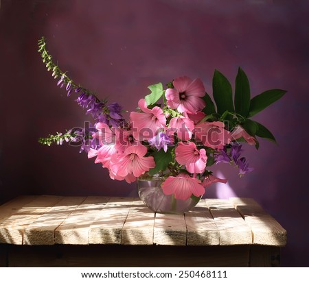 bouquet from pink and violet flowers on a violet background