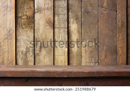 Empty wooden table against a wall from boards