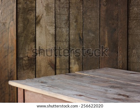 empty wooden table against a wall from boards