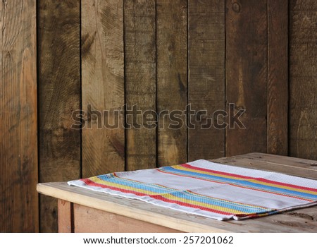 empty wooden table with a towel against a wall from boards