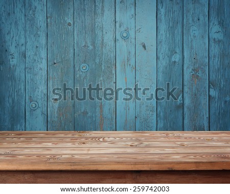 empty wooden table against a wall from boards