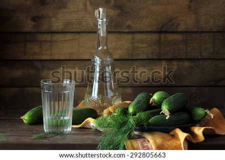 Still life with a bottle of vodka and cucumbers