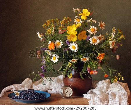 Still life with a bouquet and bilberry