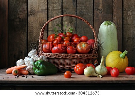 Still life with vegetables: vegetable marrow, tomato, pepper, fennel, carrots, onions, garlic, pumpkin. Vegetables in a basket. Ingredients for preparation of marrow caviar.
