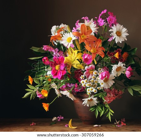 Bouquet from cultivated flowers against a dark background, a still life with a bouquet.