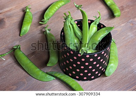 Pods of green peas on a table, the top view