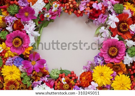 Flower background. A background from cultivated flowers and berries with a blank space in a tsenrta for your text, the top view.