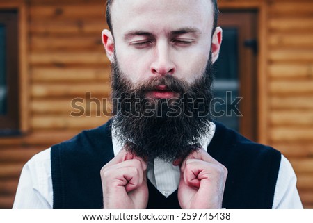 Young bearded man dreams with his eyes closed .