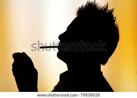 silhouette of young smoking man on white yellow  background -  back-lighting
