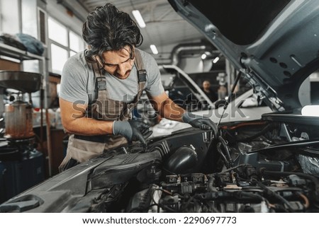 Similar – Image, Stock Photo young male mechanic works in his home workshop