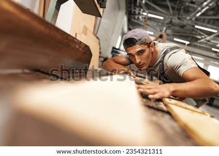 Similar – Image, Stock Photo Focused male carpenter working with wood in workshop