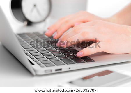Woman hands typing on laptop