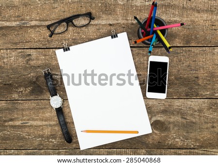 notebook and pen on wooden desk