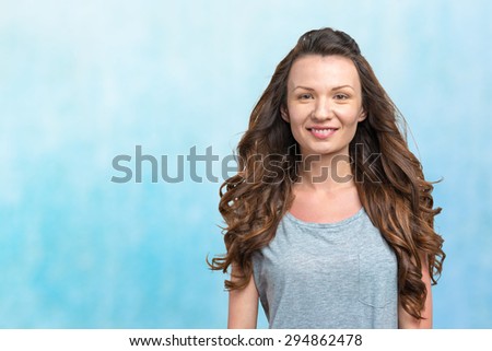 Happy young woman on blue background