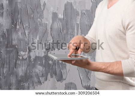 Man\'s hands using electronic device