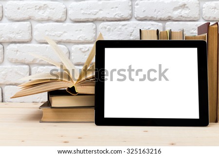 A pile of books and digital tablet