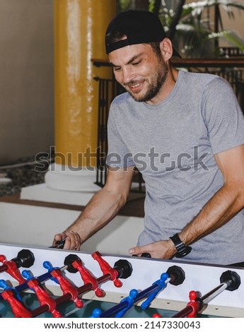 Similar – Foto Bild Junger Mann spielt Tischfußball.