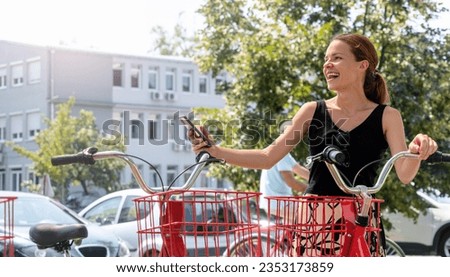 Similar – Image, Stock Photo Woman renting bike using rental app on mobile phone. Using bike sharing city service. Paid rent of electric scooter. Using smartphone to rent and pay for public eco transport