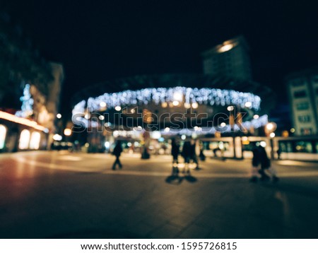 Defocused blur view of Place de l'Homme de Fer in central Strasbourg decorated for Christmas holidays with pedestrians waiting for the tramway at the stationa Stock foto © 