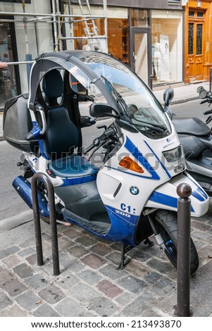 PARIS, FRANCE - AUGUST 18, 2014: BMW C1 200 scooter parked on a pedestrian area in a city street. BMW C1 is the rare enclosed scooter manufactured by Bertone for BMW  with an emphasis on safety.