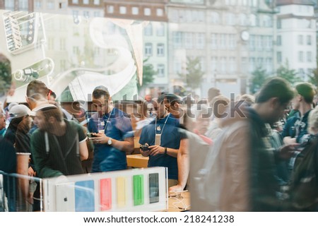 STRASBOURG, FRANCE - SEPTEMBER 19, 2014: Apple Store interior reflected with customers wait in line outside in front the store during the sales launch of the iPhone 6 and iPhone 6 Plus in Europe