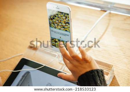 PARIS, FRANCE - SEPTEMBER 20, 2014: Kid hand playing a game on the new iPhone 6 Plus in Apple Store during the sales launch of the latest Apple Inc. smartphones at the Apple store in Paris, France