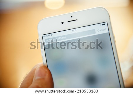 PARIS, FRANCE - SEPTEMBER 20, 2014: Hand holding a iPhone 6 Plus displaying the Search this iPhone field during the sales launch of the latest Apple Inc. smartphones at the Apple store