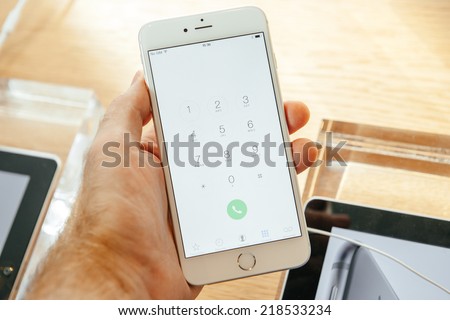 PARIS, FRANCE - SEPTEMBER 20, 2014: Hand holding a iPhone 6 Plus displaying the new dialing buttons during the sales launch of the latest Apple Inc. smartphones at the Apple store in Paris, France
