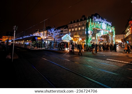 STRASBOURG, FRANCE - DEC 5, 2014: Strasbourg Place Broglie during Christmas Market with tram and pedestrians. Strasbourg is considered the most picturesque experience of Christmas spirit