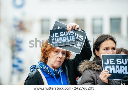 STRASBOURG, FRANCE - JANUARY 09, 2015: Council of Europe employees holding JE SUIS CHARLIE poster during a silent vigil to condemn the gun attack at French satirical magazine Charlie Hebdo in Paris