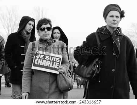 STRASBOURG, FRANCE - 11 JAN, 2015: Woman hold placard reading \'Je suis Charlie\' during a unity rally (Marche Republicaine) where some 50000 took part in tribute three-day killing spree in Paris