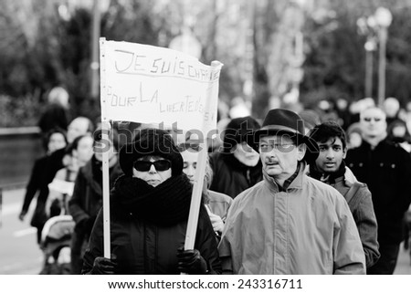 STRASBOURG, FRANCE - 11 JAN, 2015:  Woman hold placards reading \'Je suis Charlie\' during a unity rally (Marche Republicaine) where some 50000  took part in tribute three-day killing spree in Paris