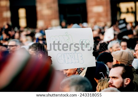STRASBOURG, FRANCE - 11 JAN, 2015: People hold placards reading \'Brasil is Charlie\' during a unity rally (Marche Republicaine) where some 50000 took part in tribute three-day killing spree in Paris