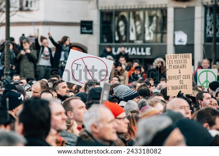 STRASBOURG, FRANCE - 11 JAN, 2015: People hold placards reading \'No to Terrorism\' during a unity rally (Marche Republicaine) where some 50000 took part in tribute three-day killing spree in Paris