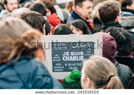 STRASBOURG, FRANCE - 11 JAN, 2015:  People hold placards reading \'Je suis Charlie\' in foreign languages during a unity rally (Marche Republicaine) where some 50000 people took part