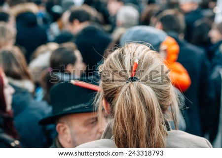 STRASBOURG, FRANCE - 11 JAN, 2015:  Woman with peincil in her hair during a unity rally (Marche Republicaine) where some 50000 people took part in tribute three-day killing spree in Paris