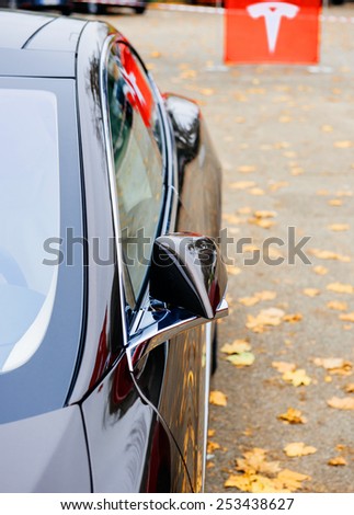 PARIS, FRANCE - NOVEMBER 29: Detail of Tesla Model S Sport Car with tesla sign in the background