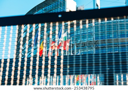 STRASBOURG, FRANCE - JAN 28, 2014: European Parliament and all Flags of European Countries seen through chainlink fence