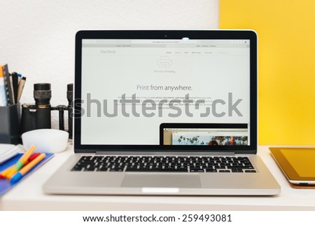 PARIS, FRANCE - MAR 10, 2015: Apple Computers website on MacBook Retina in room environment showcasing new MacBook wireless printing as seen on 10 March, 2015