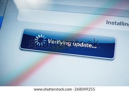 Verifying update text message on digital tablet screen - tilt-shift lens used to depict the technology background
