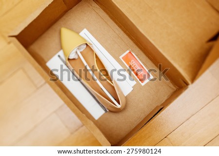 Electronic article surveillance or security tag placed in a shoe box to prevent shoplifting (also known as boosting and five-finger discount)
