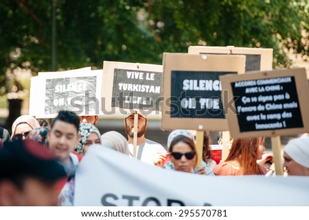 STRASBOURG, FRANCE - JULY 11, 2015: Vive le Turkistan libre placard - Uyghur human rights activists participate in a demonstration to protest against Chinese government\'s policy in Uyghur